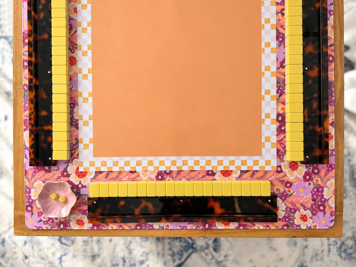 Pumpkin and Spice mahjong mat with orange center and colorful florals around the mahjong table